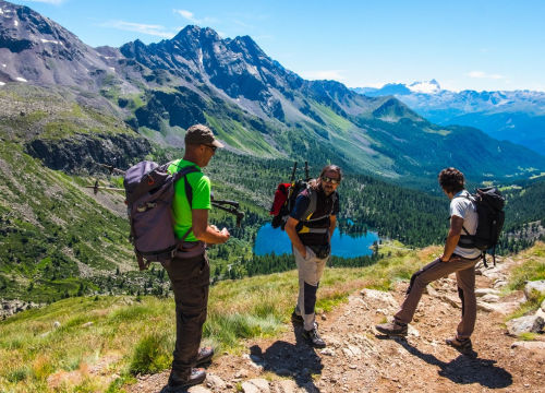 3 hikers at peak lookin down at valley and mountain range beyond near Chipeta Lodge Resort + Spa