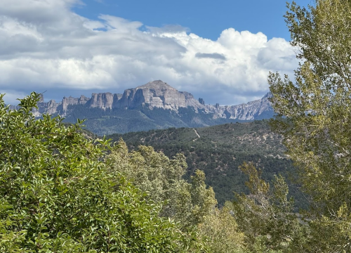 View west toward the San Juans from the rooftop bar at White Buffalo at Chipeta Lodge Resort + Spa