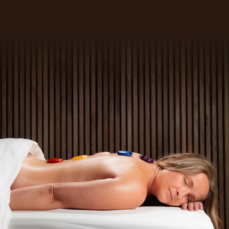 Woman Getting Stone Treatment at Chipeta Lodge Spa by ISUN at Chipeta Lodge Resort + Spa