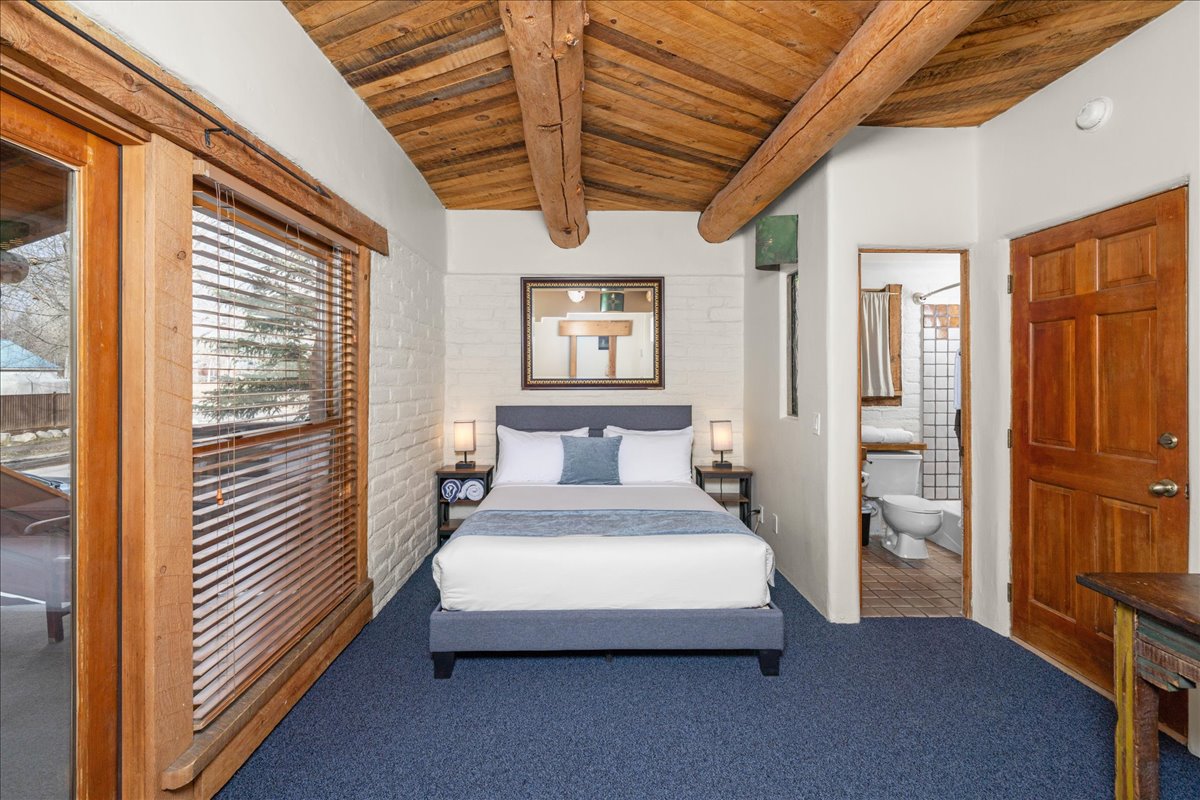 Main Bedroom with Patio and Bathroom in 2 Queen Bedroom Suite in Lodge Building at Chipeta Lodge Resort + Spa