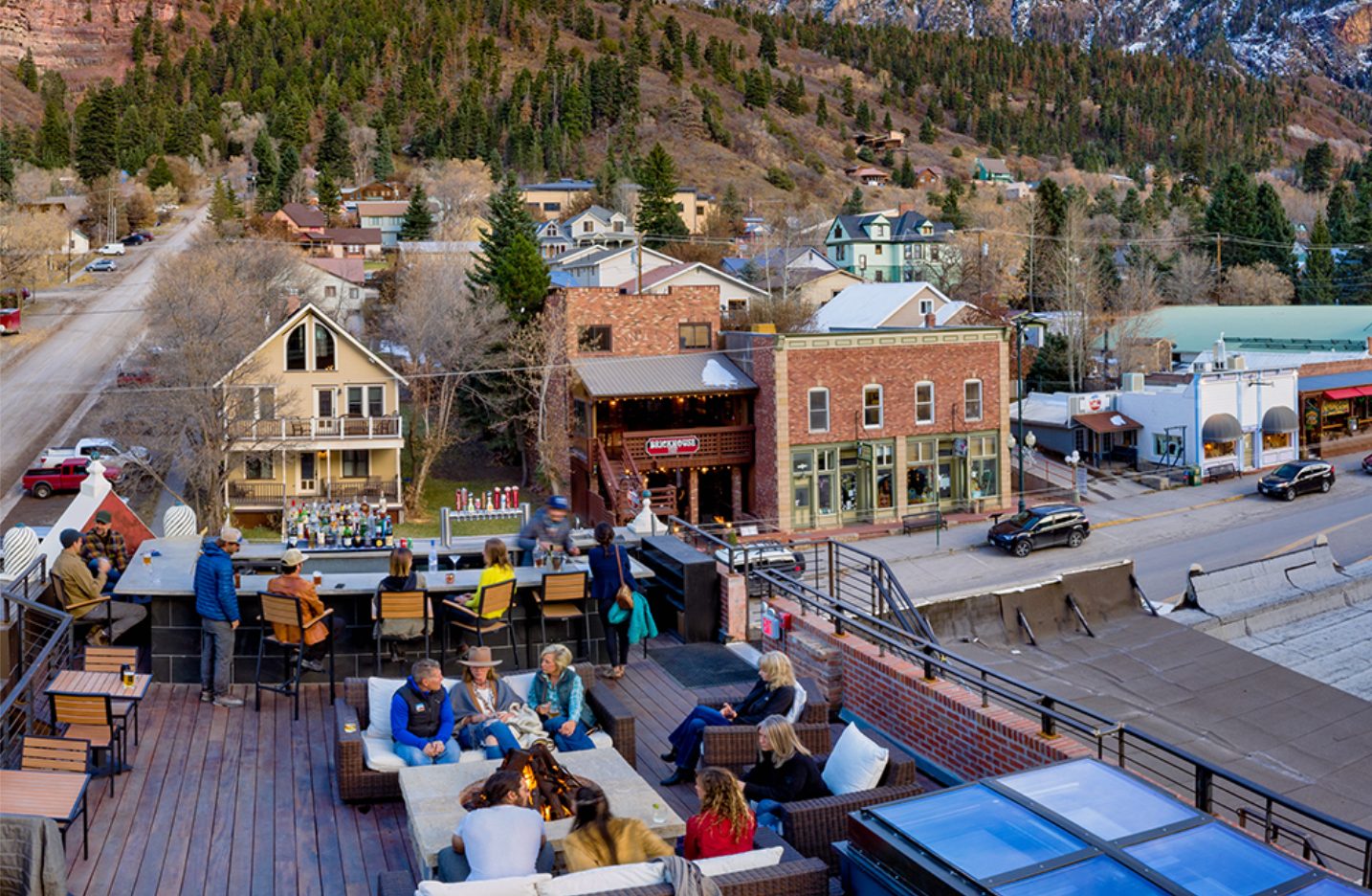 CHIP_Imogene-Rooftop-Ouray - Chipeta Lodge Resort + Spa Guests at the Imogene Hotel Rooftop bar in Ouray overlooking Main Street, near Chipeta Lodge Resort + Spa