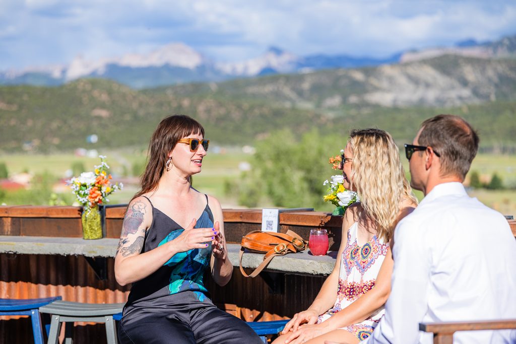 Small group enjoying cocktails at the White Buffalo Rooftop Bar at Chipeta Lodge Resort + Spa