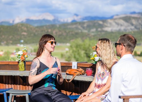 Small group enjoying cocktails at the White Buffalo Rooftop Bar at Chipeta Lodge Resort + Spa